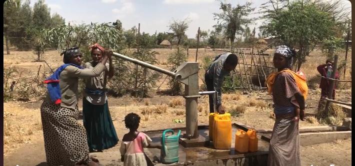 Community members collecting water at an ACTS-supported well in Ethiopia